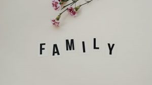 Elegant arrangement of pink flowers and family text on a white background, ideal for family themes.